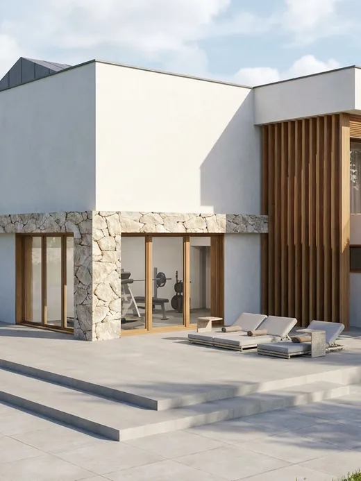 Rear facade of Duna villa with a ground-floor home gym behind glazed sliding doors, a stone-clad corner, and an upper terrace with lounge seating.