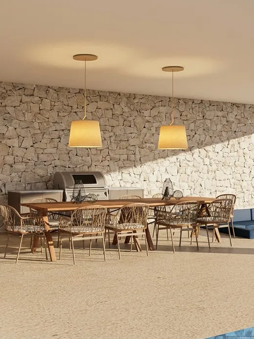 Covered outdoor dining area with a wooden table beneath pendant lights at Draguito villa.