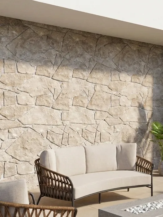 Covered terrace with a stone accent wall, woven lounge chairs, and a built-in fire pit table overlooking the garden.