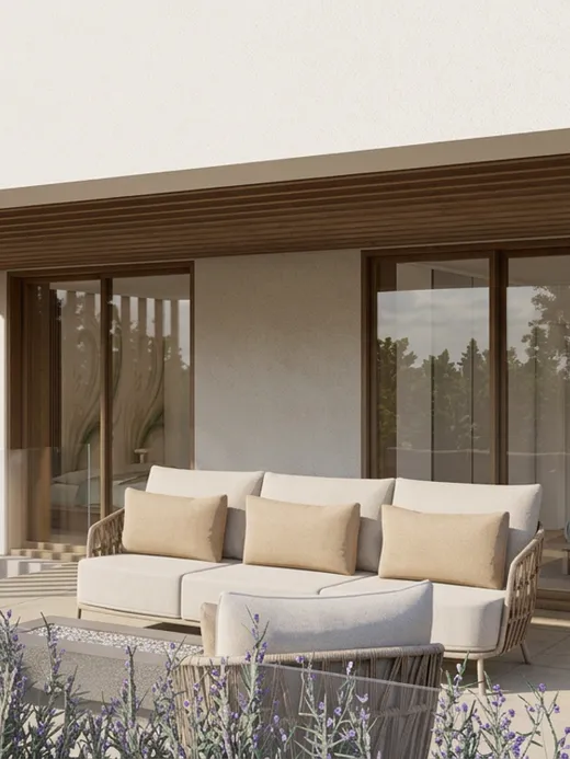 Covered terrace with a timber-slat canopy, a beige outdoor sofa, a built-in fire pit, and views into a lavender border and pine trees.