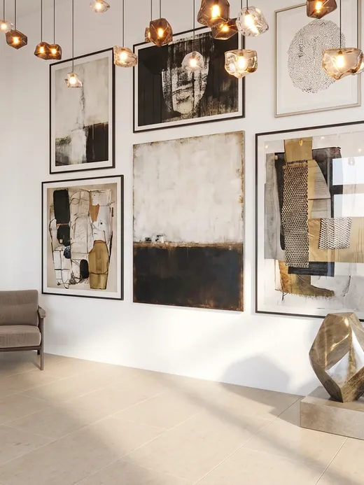 Render of the double-height entrance gallery hung with abstract artworks and sculptures beneath a cluster of pendant lights.