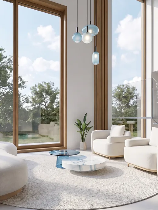 Double-height living room with floor-to-ceiling timber-framed windows, curved bouclé armchairs, a marble coffee table, and a floating staircase leading to the dining area beyond.