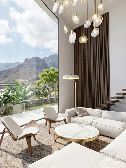Double-height living room with a floor-to-ceiling glazed corner, a cascading round-bulb pendant light, a floating timber stair, and mountain views.