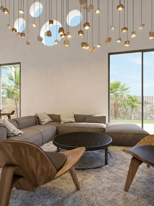 Living room with a modular grey sectional sofa, wood-shell lounge chairs, and full-height sliding glass doors to the garden.