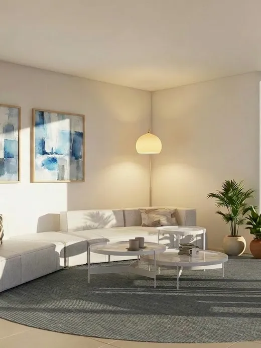 Secondary lounge at Draguito villa with a light sectional sofa and views onto a palm-lined terrace.