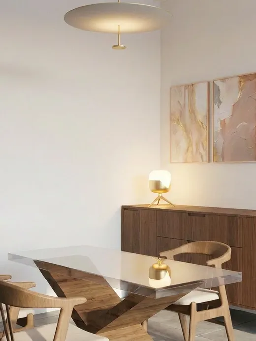 Home office nook with a sculptural glass-and-timber desk, woven dining chairs, a walnut sideboard, and a triptych of abstract art.