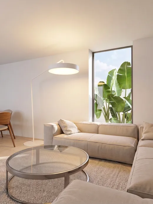 Render of the living and dining area with a corner sofa, wood dining table and a large botanical mural on the end wall.