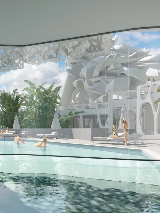Indoor-outdoor pool framed by organic white lattice screens and teal mosaic walls, opening to a palm garden.